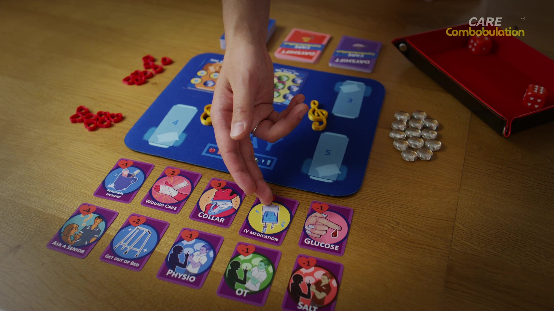 A player choosing an illustrated care card beside the Dayshift bay board