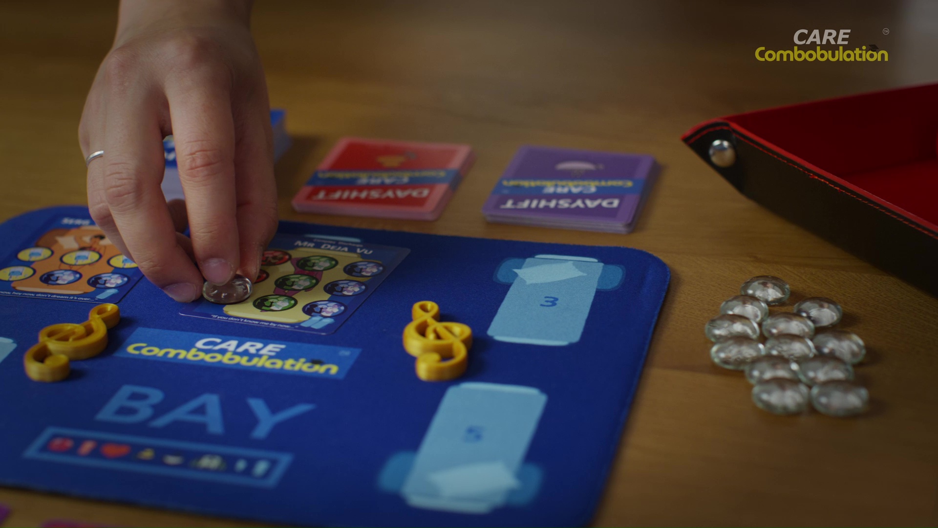A player placing a clear counter on a Dayshift patient card