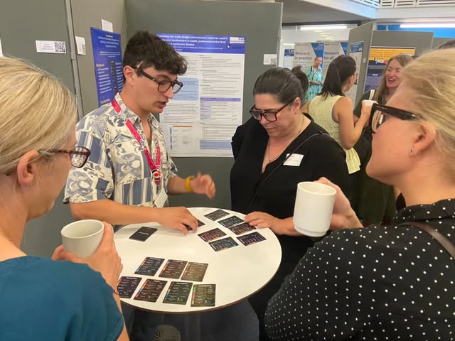 People exploring educational game cards together at a research event