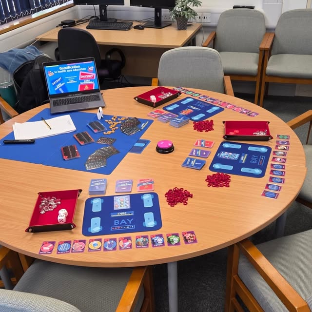 Dayshift boards, cards, dice and counters arranged around a training-room table