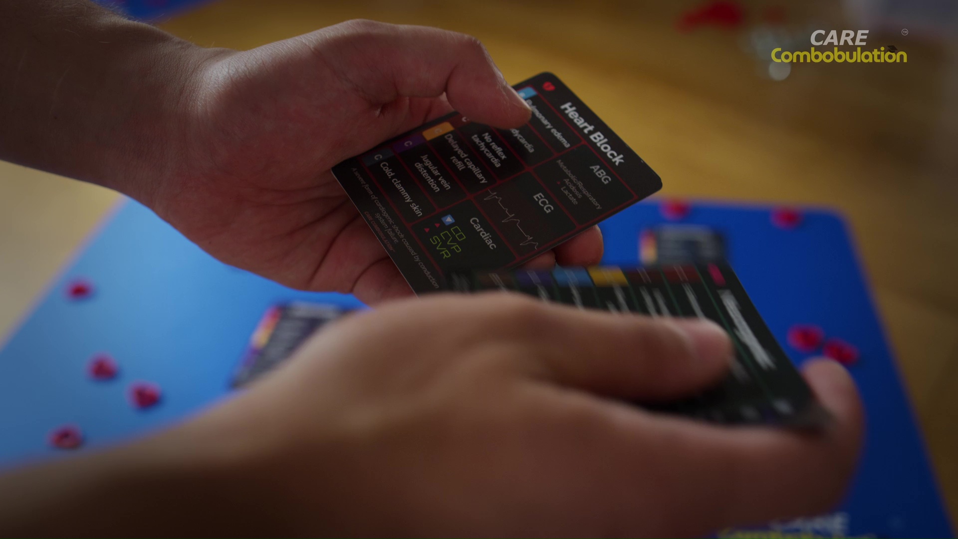 A player holding a Shock Who heart block card above the playing mat