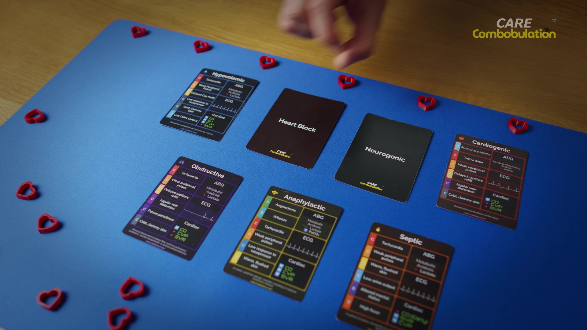 Shock Who cards laid out on a blue mat with red heart counters